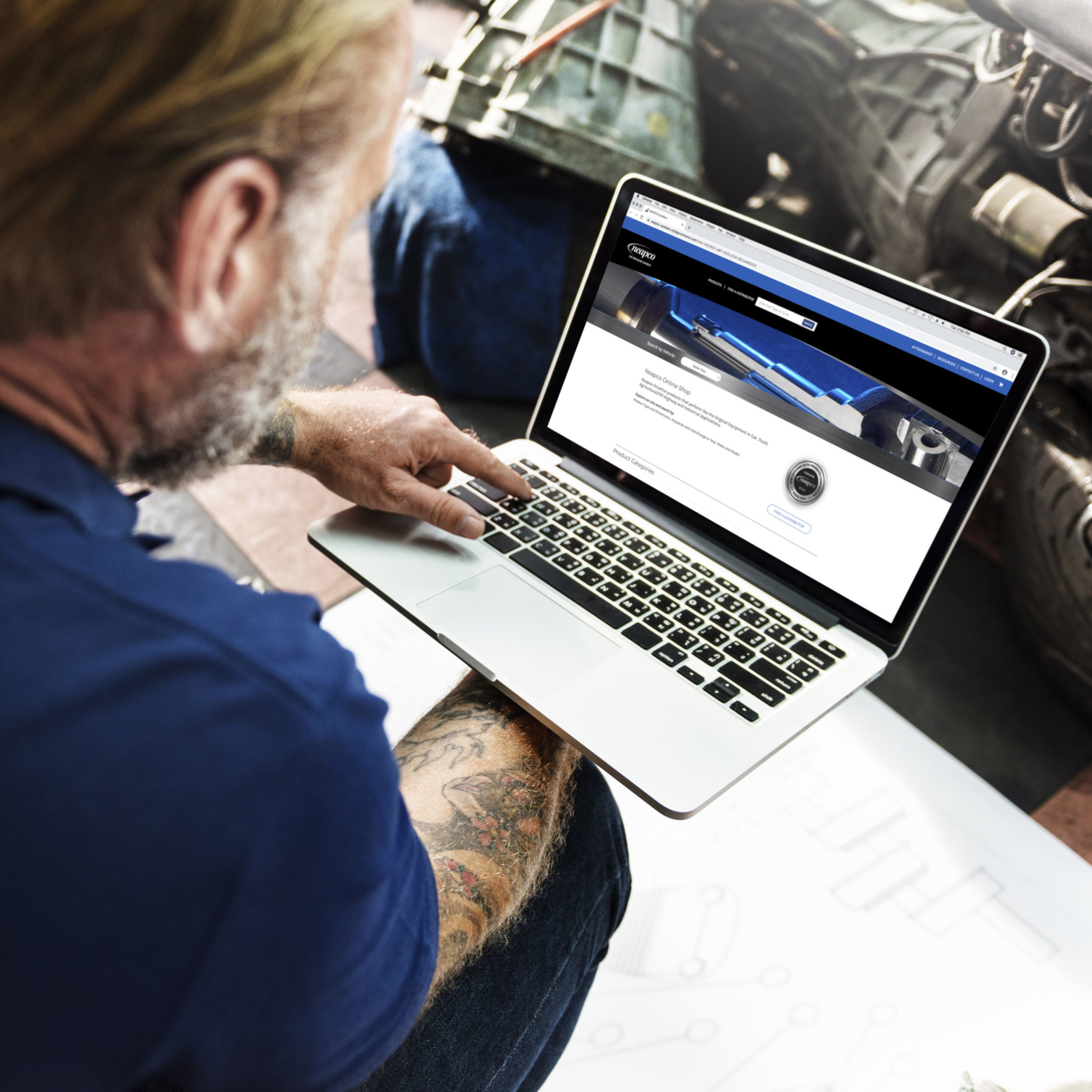 Man on a laptop visiting Neapco website