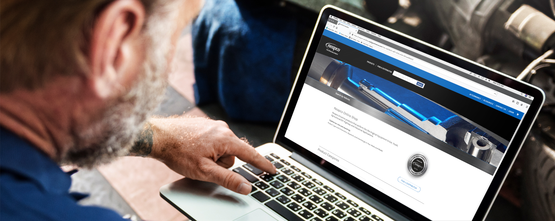 Man using Neapco parts website on laptop